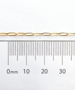 Gold filled paperclip chain shown against a ruler