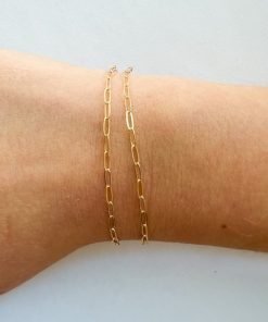 gold filled paperclip chain shown on a woman's wrist for size.